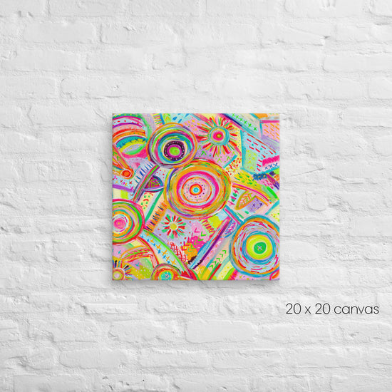 A vibrant 20x20-inch Summer Sorbet canvas by My Favourite Colour is Rainbow, featuring abstract circular and geometric patterns in pink, green, orange, and yellow, is mounted on a textured white brick wall.