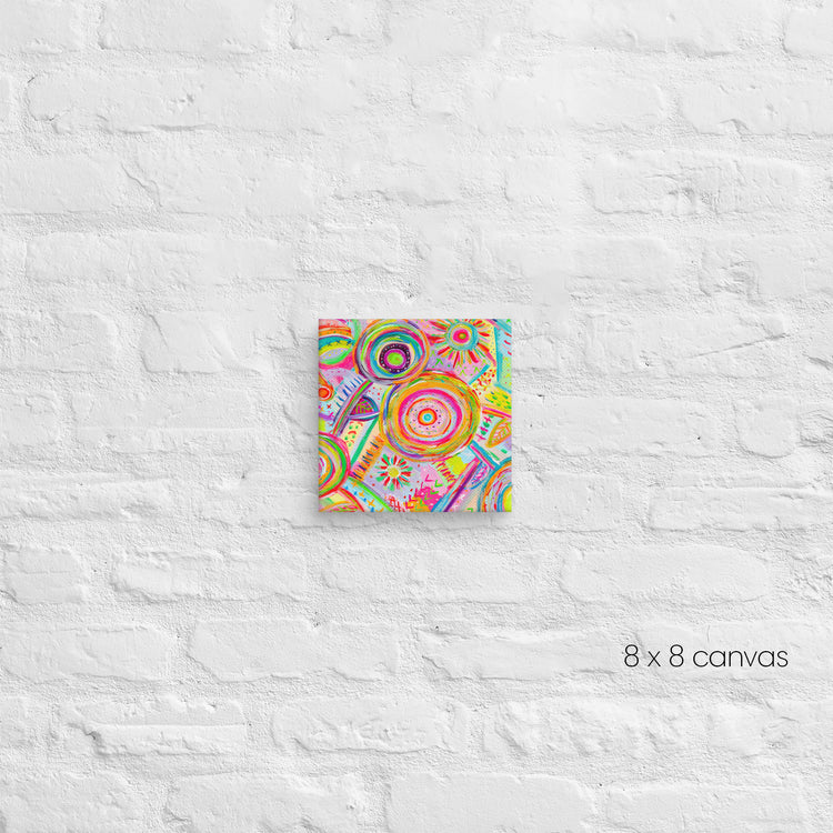 A vibrant 8 x 8-inch Summer Sorbet canvas by My Favourite Colour is Rainbow, featuring abstract circular and geometric patterns in pink, green, orange, and yellow, is mounted on a textured white brick wall.