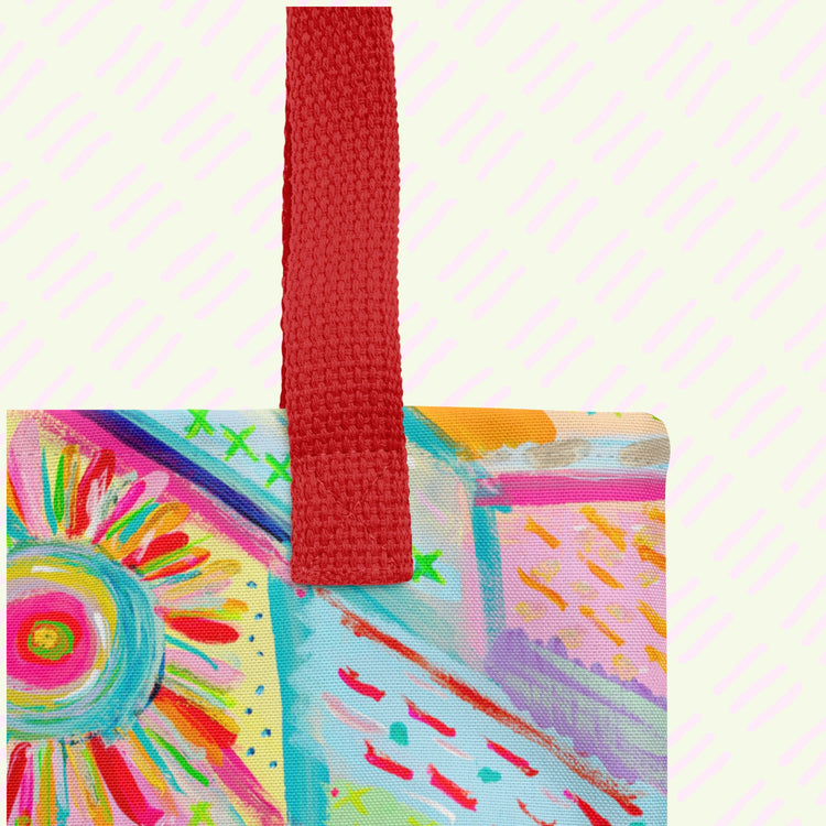 A close-up of the Summer Sorbet Tote Bag by My Favourite Colour is Rainbow,  featuring a vibrant abstract pattern, and a sturdy red strap.