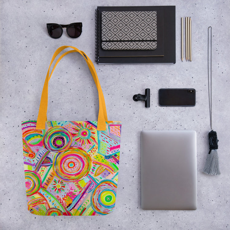 Flat lay featuring the yellow-handled Summer Sorbet tote bag by My Favourite Colour is Rainbow, surrounded by items like sunglasses, notebooks, a mobile phone and laptop.