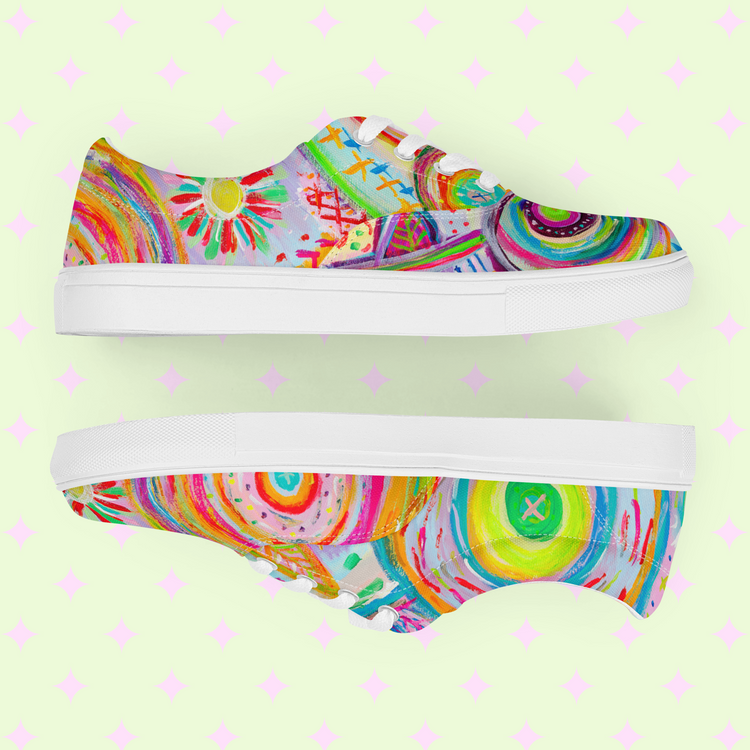 Two vibrant Summer Sorbet Canvas Sneakers by My Favourite Colour is Rainbow feature abstract swirls, circles, and geometric shapes on a pastel green background with pink diamond patterns; one upright like a sorbet treat and the other lying on its side.