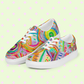 The Summer Sorbet Canvas Sneakers by My Favourite Colour is Rainbow feature vibrant abstract designs with swirls, lines, and circles in pink, green, blue, yellow on a pale green background with pink diamonds.