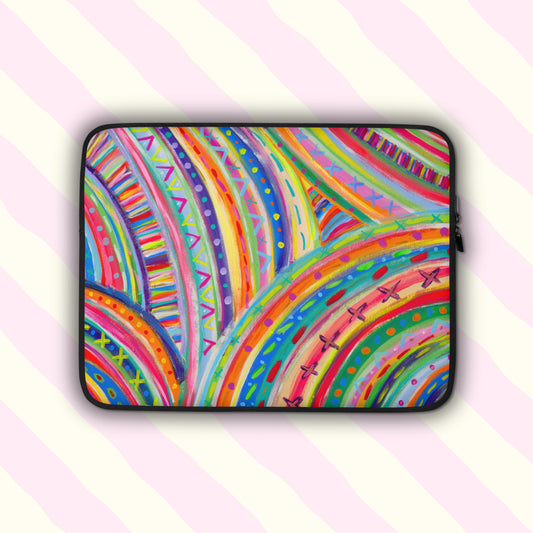 The Rainbow Connection Laptop Sleeve, by My Favourite Colour is Rainbow, features a colourful design with an abstract pattern of curved lines, dots, and triangles in vibrant pink, orange, green, blue, and yellow.