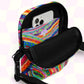 The Rainbow Connection Mini Crossbody Bag by My Favourite Colour is Rainbow has a vibrant abstract swirl and dot design in bright colors. It features an open main compartment, roomy pockets—including one for a smartphone—and black adjustable straps with a secure buckle.