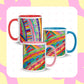 Three Rainbow Connection Mugs from My Favourite Colour is Rainbow, shown from different sides. The mugs feature my The Rainbow Connection painting, featuring bright sweeps of colour and abstract doodles of stripes, dots and other shapes . The mug is available with red, blue, or pink interiors and handle.