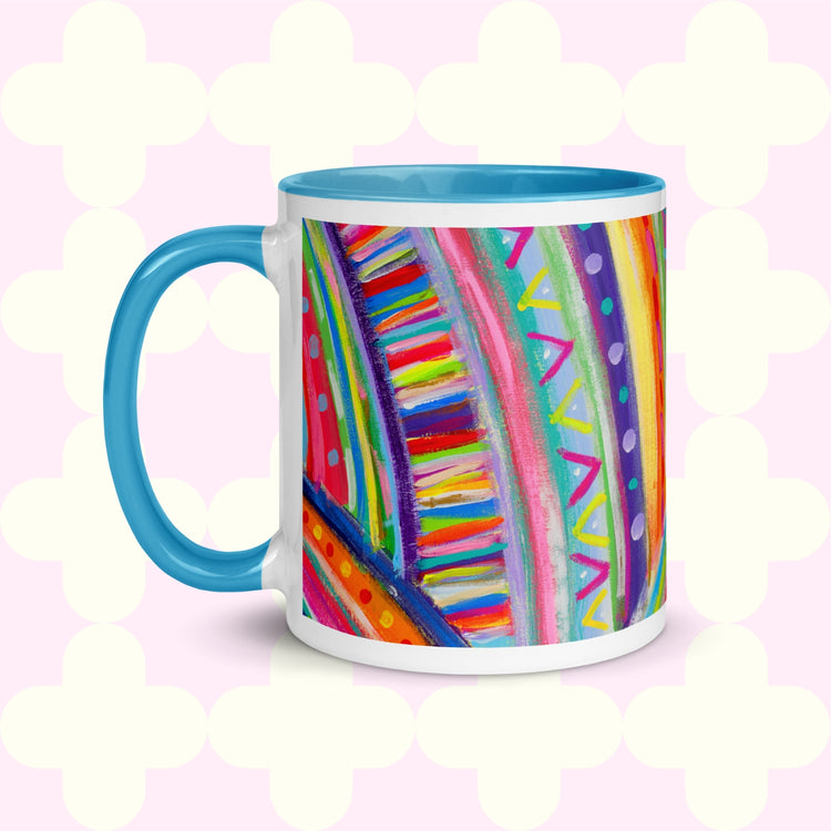 The Rainbow Connection Mug by My Favourite Colour is Rainbow features a blue handle and rim, adorned with abstract patterns like stripes, triangles, and dots in bright pink, blue, yellow, and green .