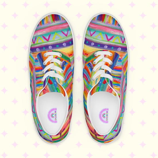 Unleash a colorful adventure with The Rainbow Connection Canvas Sneakers by My Favourite Colour is Rainbow, showcasing intricate geometric patterns in vibrant pink, orange, blue, green, and yellow with white laces and soles on a light backdrop adorned with pink diamond shapes.