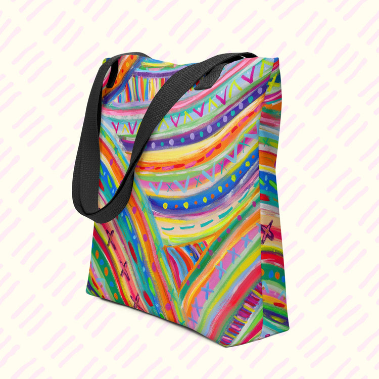 The Rainbow Connection Tote Bag from My Favourite Colour is Rainbow features vibrant abstract patterns in rainbow hues with black handles and a spacious design.