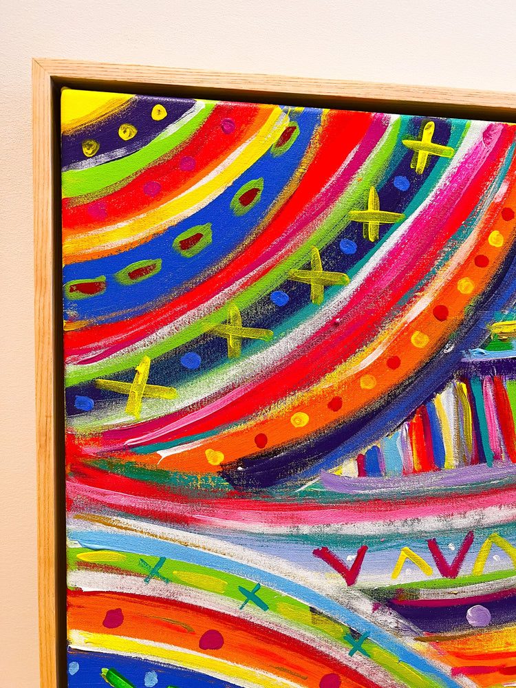 Close-up of The Rainbow Connection, an acrylic painting with red, orange, purple, and blue waves plus vibrant green and yellow X shapes. Professionally framed in light wood from My Stores The Rainbow Connection Framed Original Painting collection.