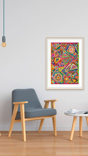 A minimalist room showcases a wooden armchair, round side table, and hanging bulb. On the white wall, My Stores Tropical Geometry Fine Art Print adds vibrant energy. A cup on the table invites reflection in this artful setting.