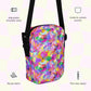 An infographic highlighting features of the Watercolour Rainbow Mini Crossbody Bag by My Favourite Colour is Rainbow: adjustable shoulder strap, inside and outside pocket, sturdy canvas fabric and a two-way zipper. 