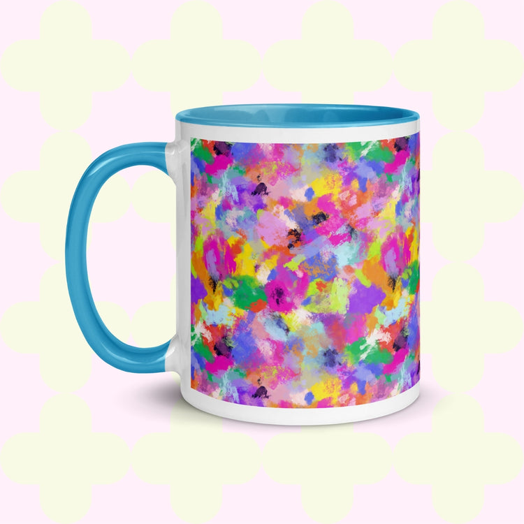 The Watercolour Rainbow Mug by My Favourite Colour is Rainbow features a vibrant abstract design with pink, blue, yellow, green, and purple splashes. It has a blue handle and interior .