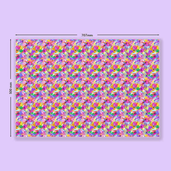 The Watercolour Rainbow Wrapping Paper Sheets by My Favourite Colour is Rainbow feature a colourful abstract pattern on recycled paper, measuring 707mm x 500mm, with vibrant tones of pink, purple, yellow, and green.  The wrapping paper is shown on a light purple background.