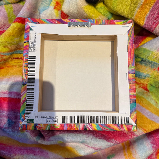 The rear of my canvas artworks include production barcodes which are not visible when hung.  The artworks include a sawtooth hook for easy hanging.